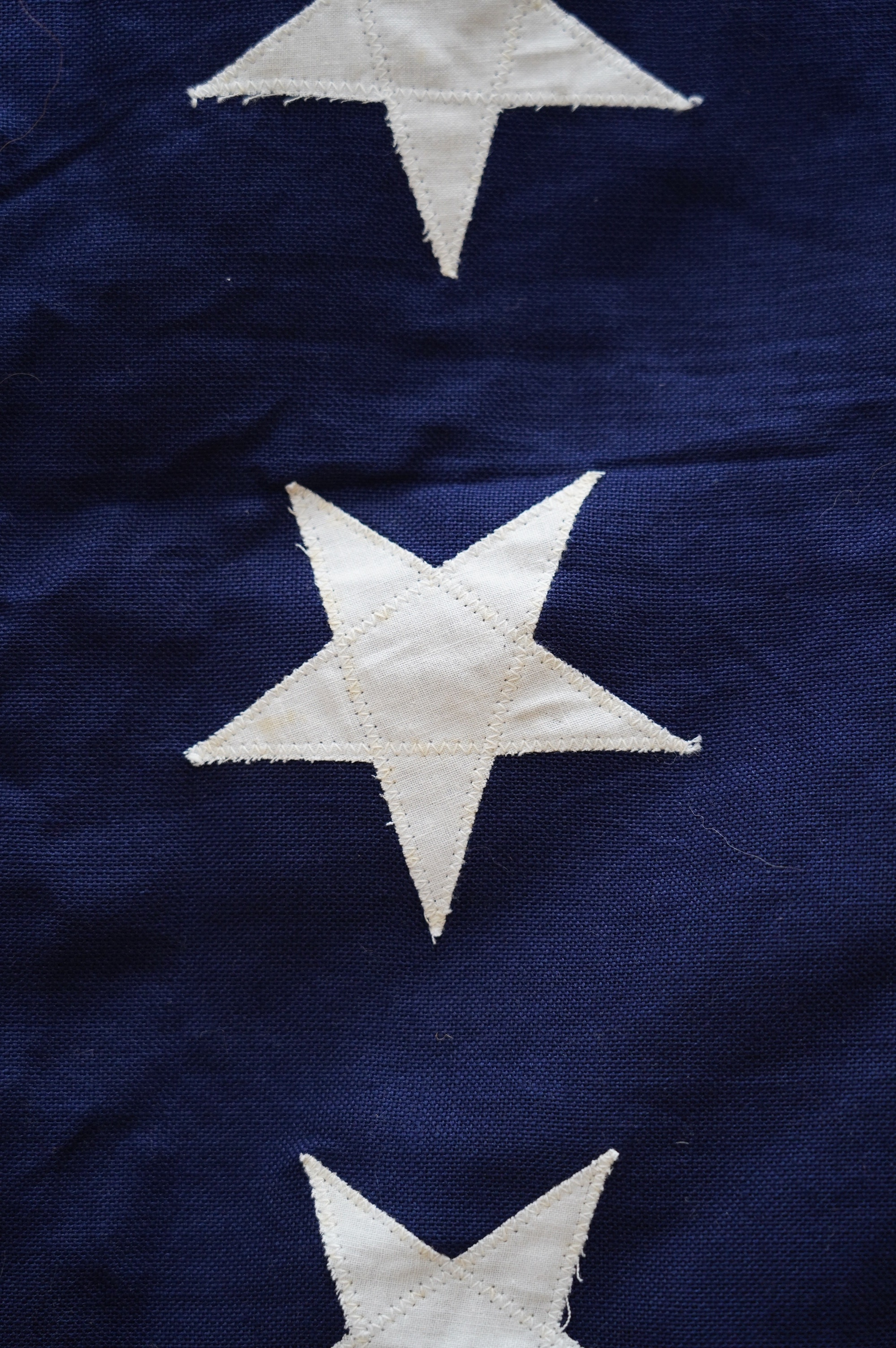 Four flags; two professionally made US Stars and Stripes, both on thick canvas with applied stars and joined stripes, one by the Valley Forge Flag Co., Pennsylvania, stamped “5 x 9.5 ft”, 146 x 288cm and 176 x 300cm, tog